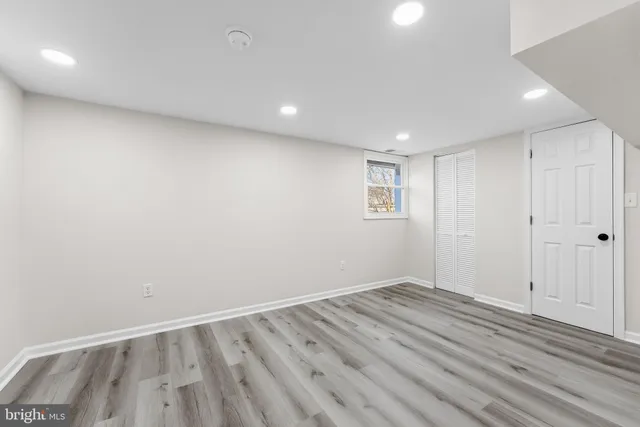 a view of room with wooden floor and window