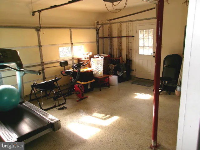 a living room with furniture a air conditioner vent and a window