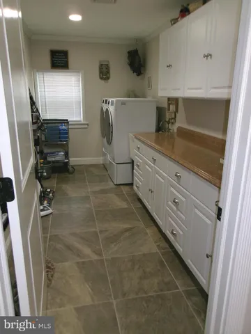 a kitchen with a sink stainless steel appliances a counter top space and cabinets