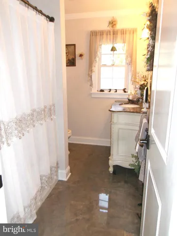 a room with a window and a kitchen