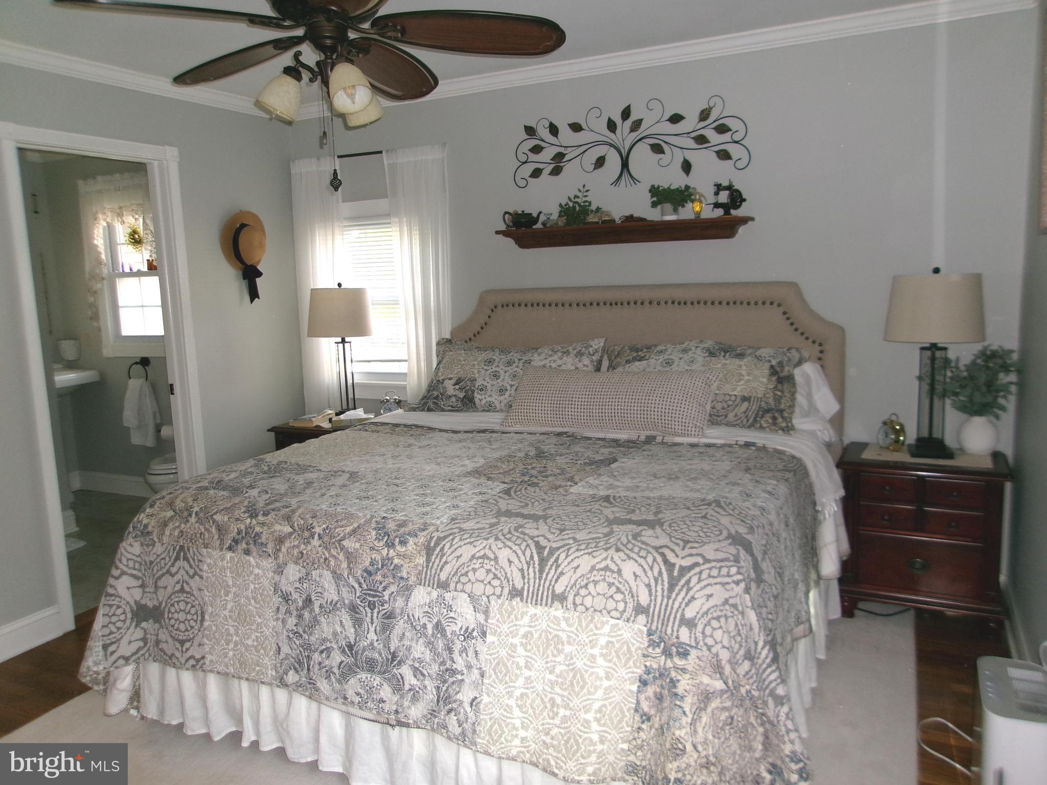 22 Nugentown Road Tuckerton, NJ 08087 - Photo 16 of 37 a bedroom with a large bed and a chandelier
