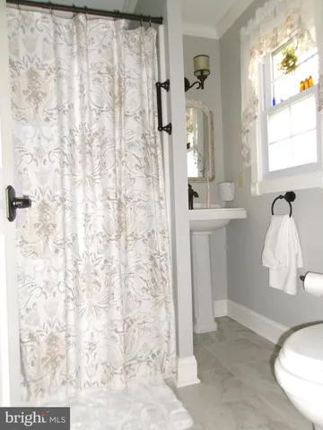 a bathroom with a sink a mirror and shower