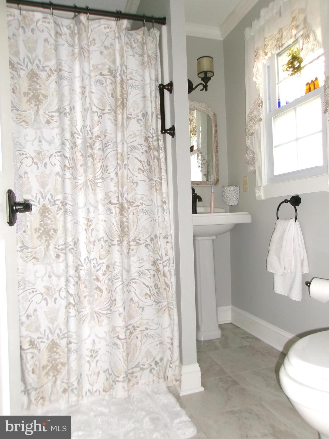 22 Nugentown Road Tuckerton, NJ 08087 - Photo 17 of 37 a bathroom with a sink a mirror and shower