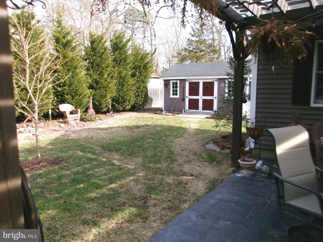 a backyard of a house with yard and outdoor seating