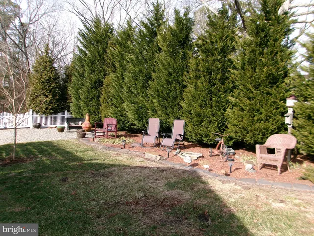 a view of a backyard with sitting area