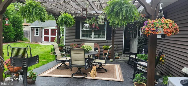 a view of a house with backyard and sitting area