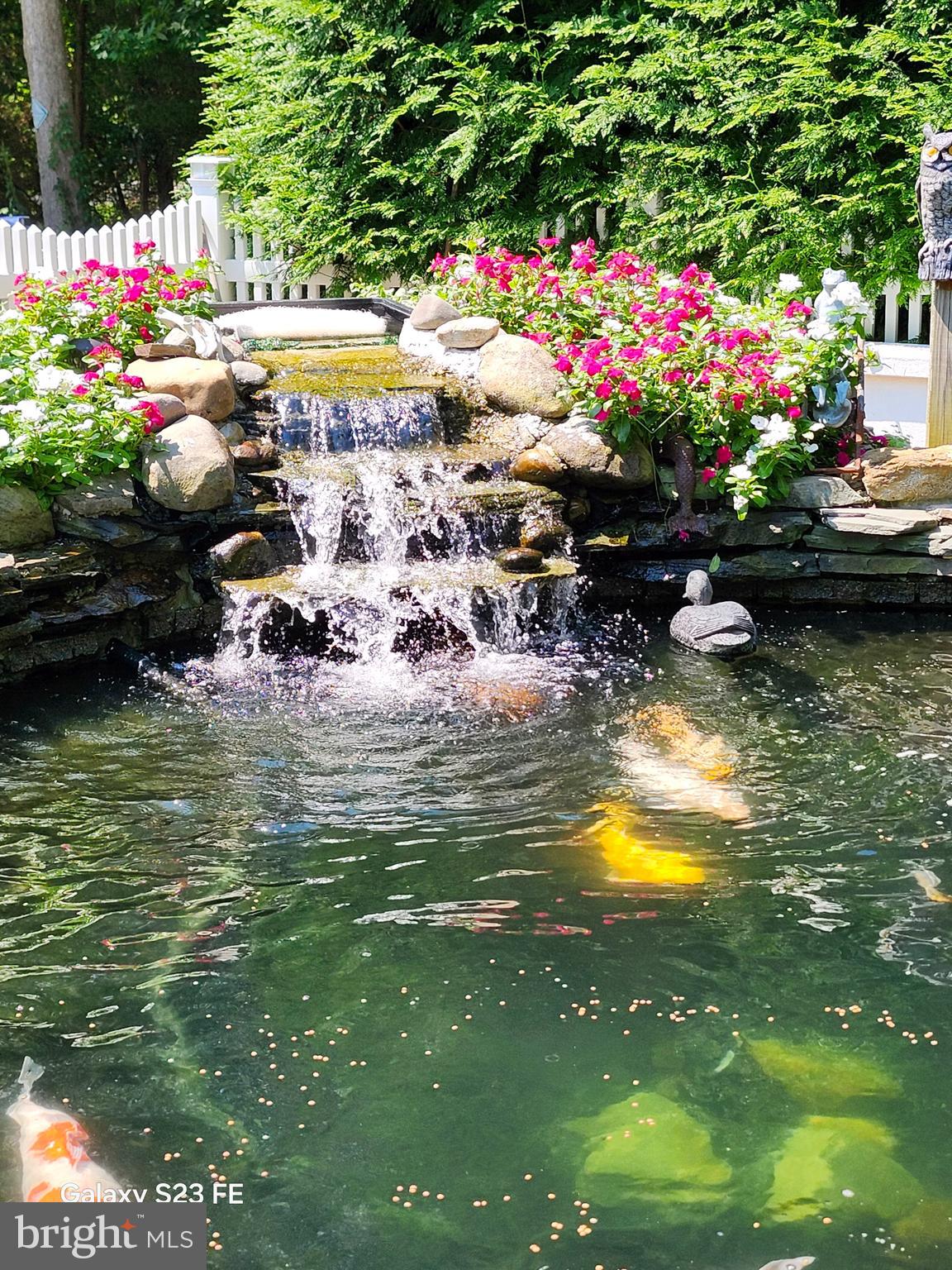 22 Nugentown Road Tuckerton, NJ 08087 - Photo 33 of 37 a view of a lake with a table and chairs and potted plants