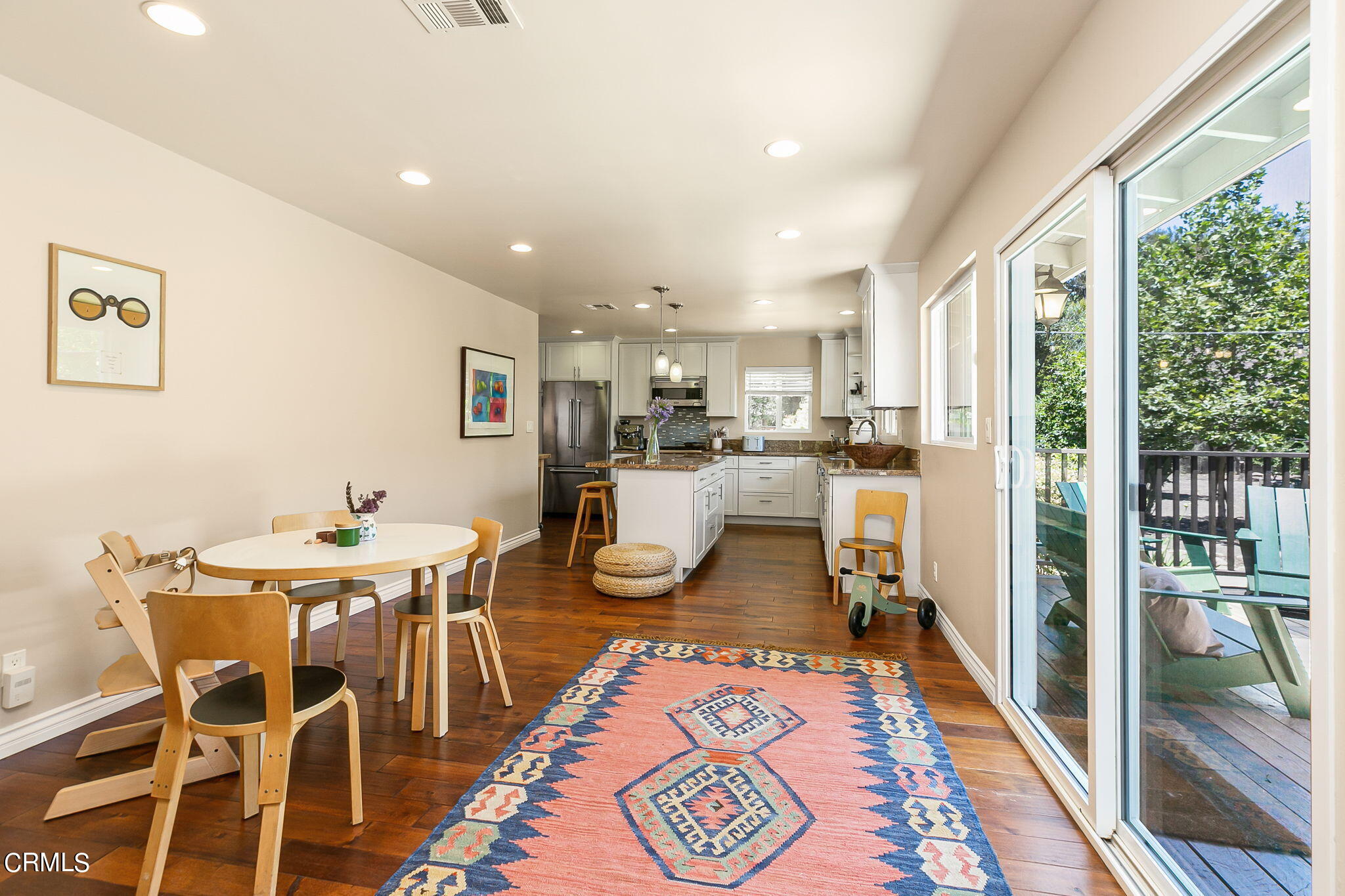 807 Daly Road Ojai, CA 93023 - Photo 15 of 50 a room with stainless steel appliances a dining table wooden floor and a large window