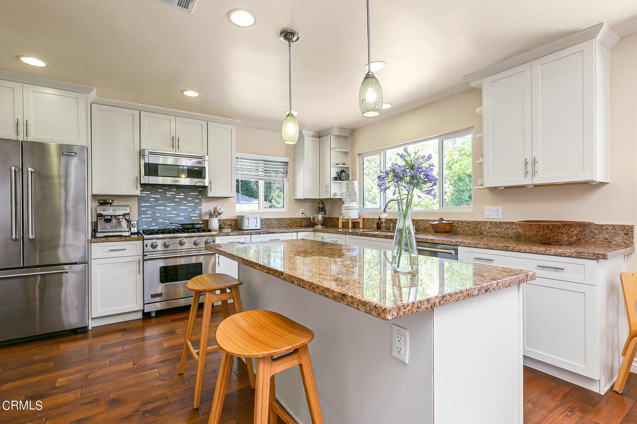 807 Daly Road Ojai, CA 93023 - Photo 19 of 50 a kitchen with stainless steel appliances granite countertop a refrigerator a sink dishwasher a stove and white cabinets with wooden floor