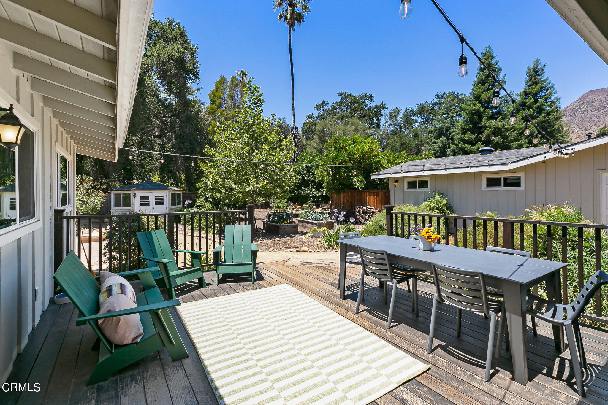 807 Daly Road Ojai, CA 93023 - Photo 33 of 50 a balcony with wooden floor table and chairs