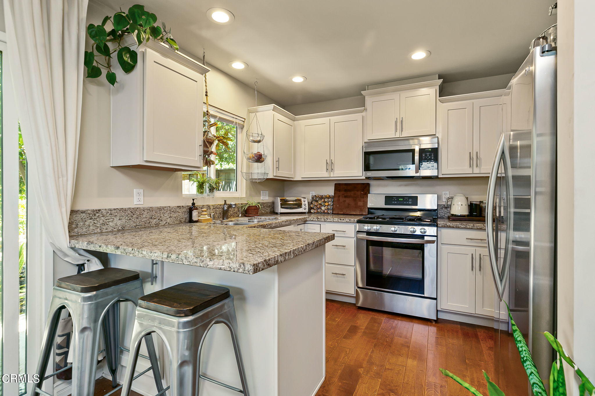 807 Daly Road Ojai, CA 93023 - Photo 46 of 50 a kitchen with stainless steel appliances granite countertop a sink a stove a refrigerator and a microwave