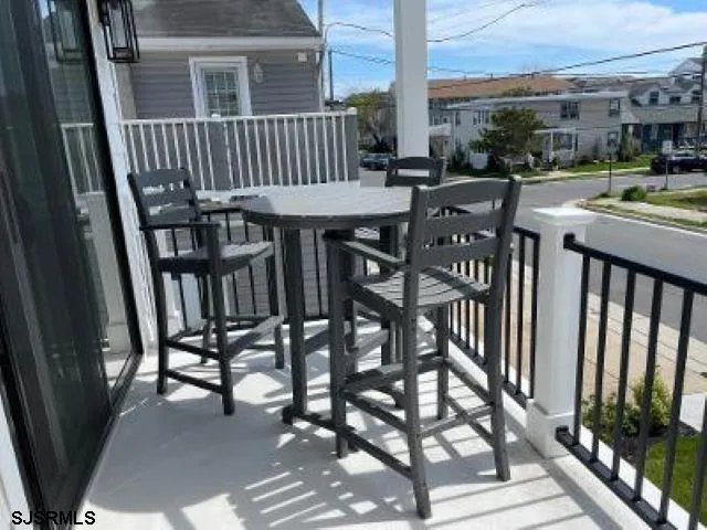 a view of a chairs and table in the balcony