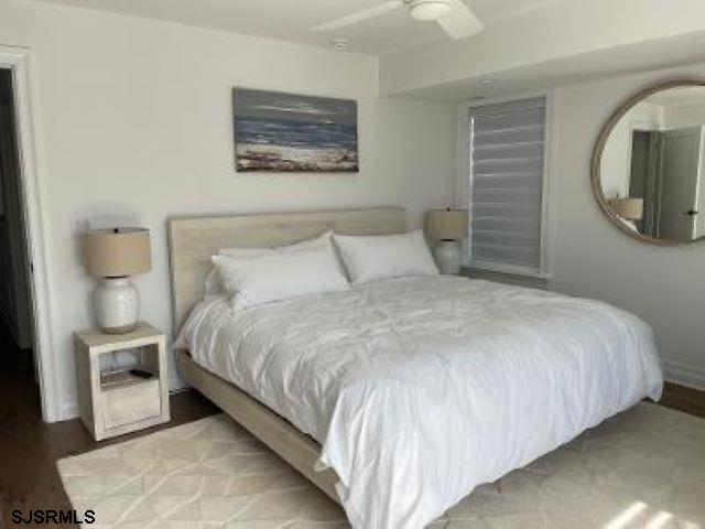 103 North Monroe Avenue, Unit ALSO AVAILABLE STARTING MAY 15 Margate City, NJ 08402 - Photo 18 of 33 a large bed sitting in a bedroom next to a window