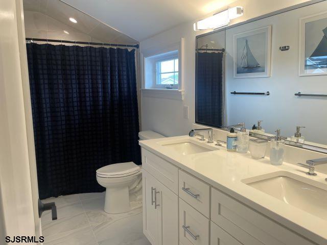 103 North Monroe Avenue, Unit ALSO AVAILABLE STARTING MAY 15 Margate City, NJ 08402 - Photo 27 of 33 a bathroom with a sink and a toilet