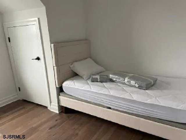 a bedroom with a bed and a mirror