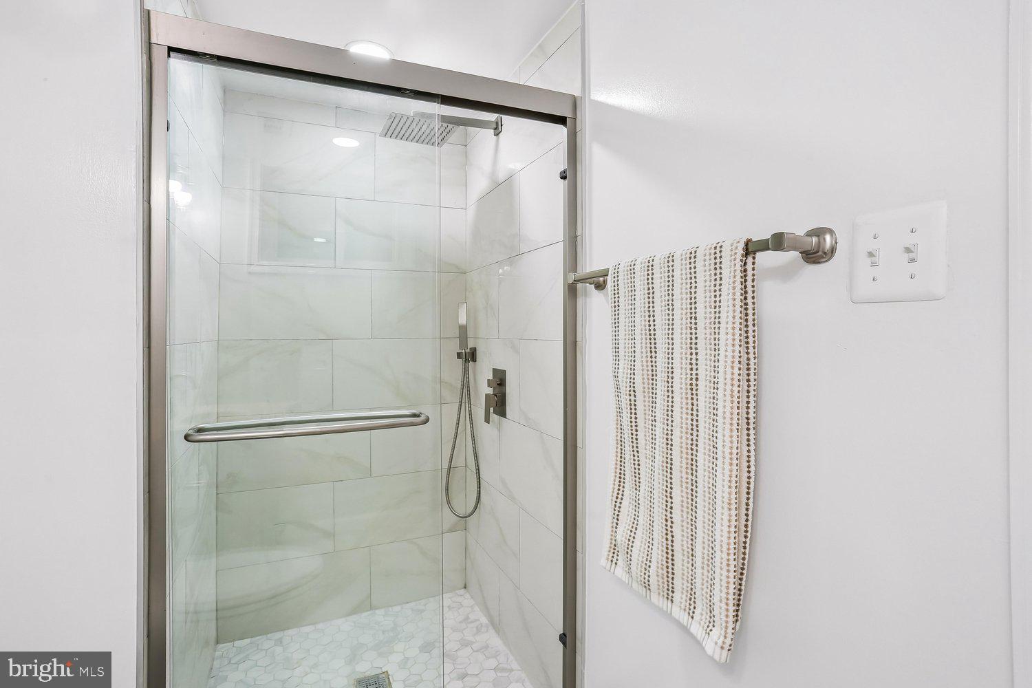 907 Hoyt Street Silver Spring, MD 20902 - Photo 53 of 69 a bathroom with a glass shower door