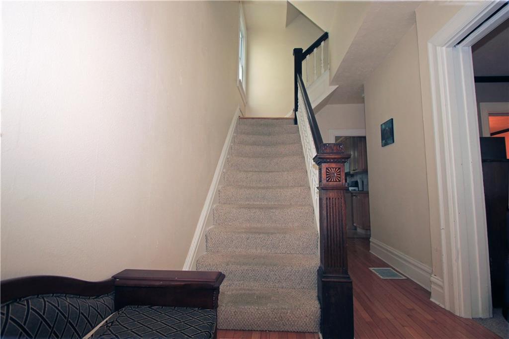 915 Malvern Road Pittsburgh, PA 15202 - Photo 12 of 23 The steps to the second floor have a custom wood banister with wood spindles and hand rail. The steps have nice neutral carpet all the way to the second floor.