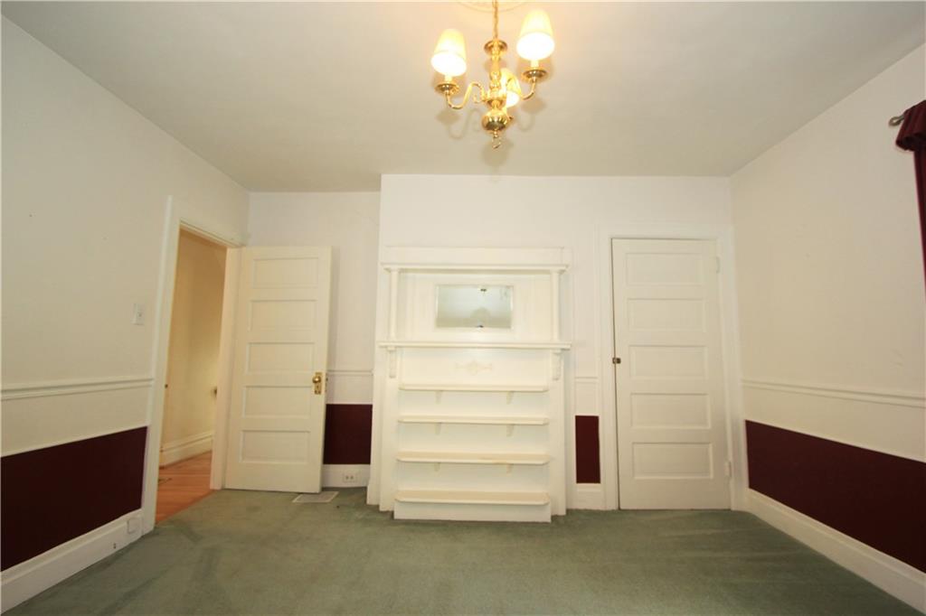 915 Malvern Road Pittsburgh, PA 15202 - Photo 16 of 23 This alternate view of the second bedroom shows the built in shelves, the door to the closet and the entry door to the room.