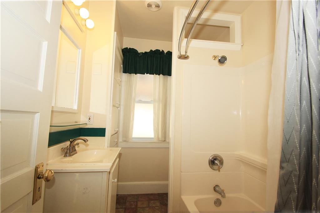 915 Malvern Road Pittsburgh, PA 15202 - Photo 19 of 23 The spacious second floor bath has a full tub with a shower, vanity with a single bowel sink, lighted mirror and a separate toilet area beyond the shower.