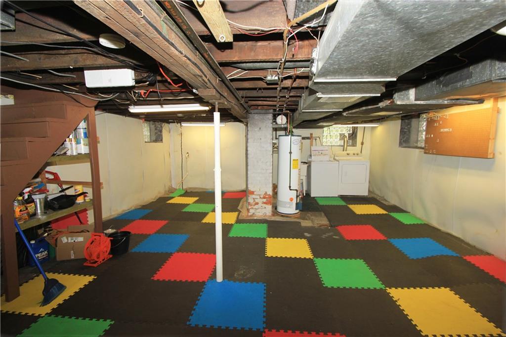 915 Malvern Road Pittsburgh, PA 15202 - Photo 21 of 23 This view of the basement shows the laundry area in the back right side of the basement. The basement has a interior French drain around the whole perimeter which includes special panels over the sandstone foundation.