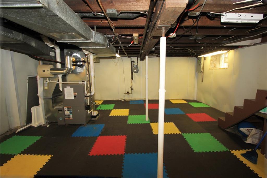 915 Malvern Road Pittsburgh, PA 15202 - Photo 22 of 23 This alternate view of the basement highlights the glass block window at the base of the stairs, the high efficient furnace and the electric panel breaker box in the back right side of the picture. The floor is covered with colored rubber mats. Plenty of room for exercise equipment, storage or whatever you like!