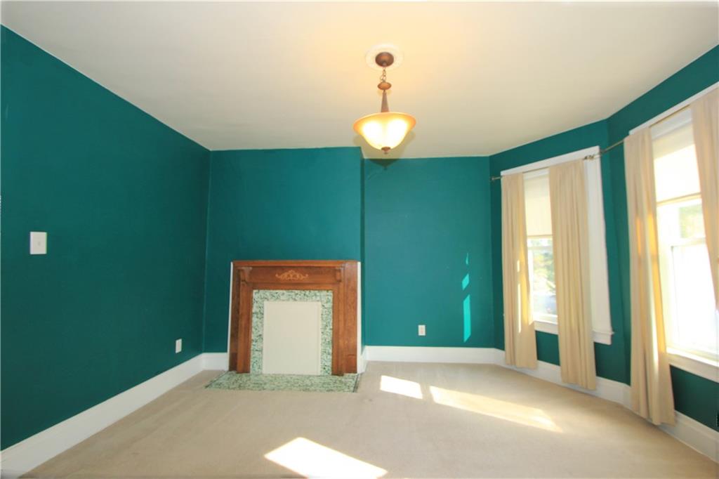 915 Malvern Road Pittsburgh, PA 15202 - Photo 5 of 23 This picture focuses on the decorative fireplace with a beautiful wood mantel in the master bedroom. The character in this house continues from one floor to the next