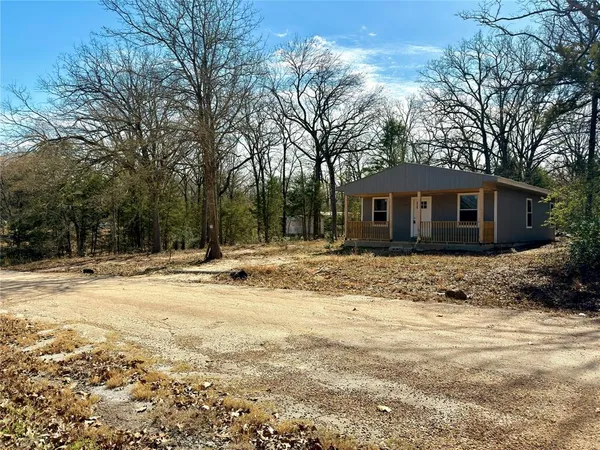 a view of a house with a yard covered with snow