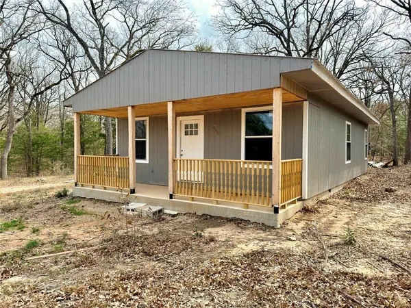 a view of a porch with a floor to ceiling window and wooden fence