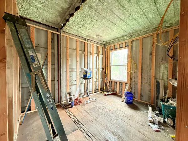 a view of a room with furniture and a window
