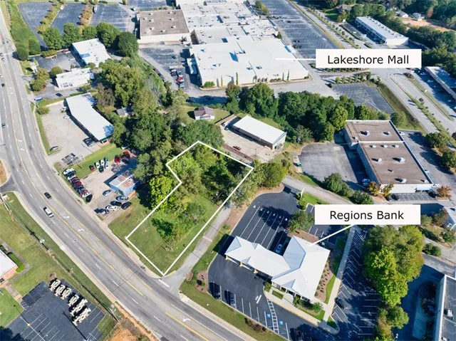 an aerial view of a residential apartment building with a yard