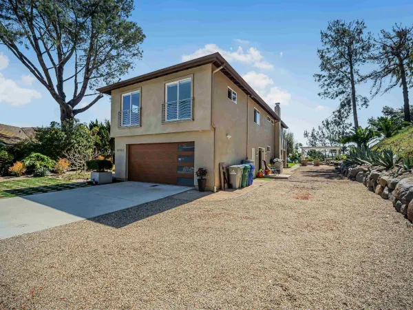 an aerial view of a house with swimming pool garden and patio