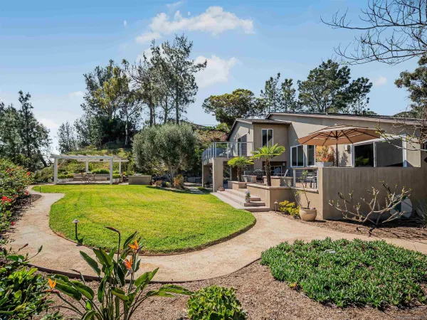 a view of kitchen with kitchen island stainless steel appliances refrigerator stove dining table and chairs