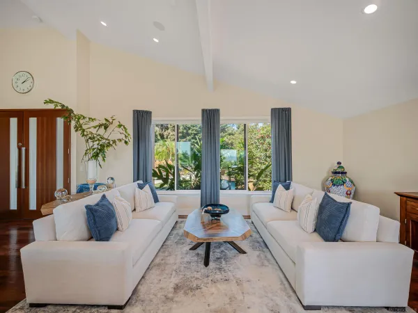 a living room with furniture a large window and a flat screen tv