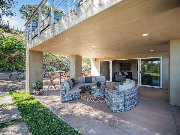 a bedroom with a bed a window and flat screen tv
