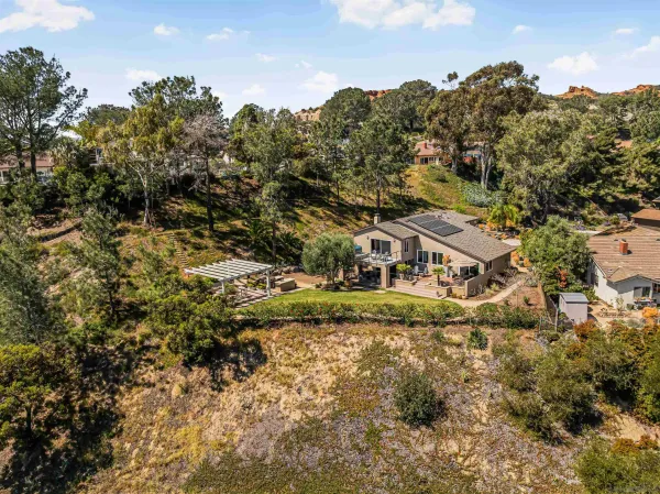 an aerial view of a house with a yard