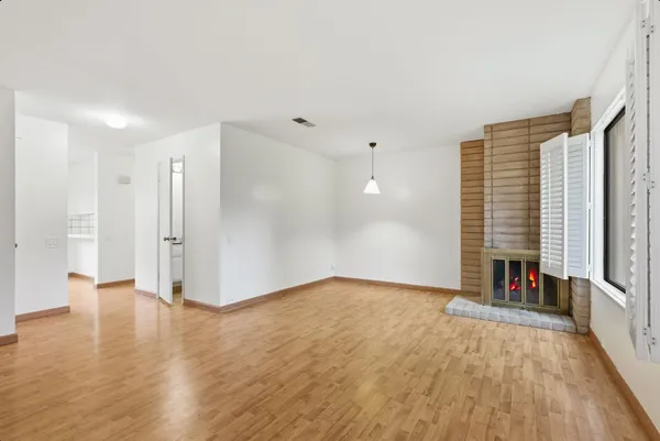 wooden floor in an empty room with a window