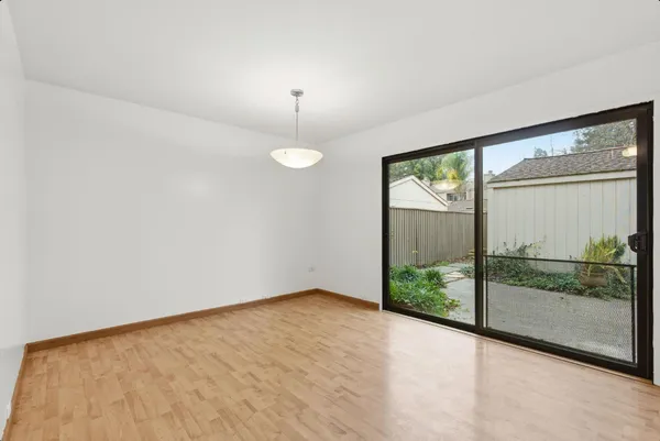a view of an empty room with windows