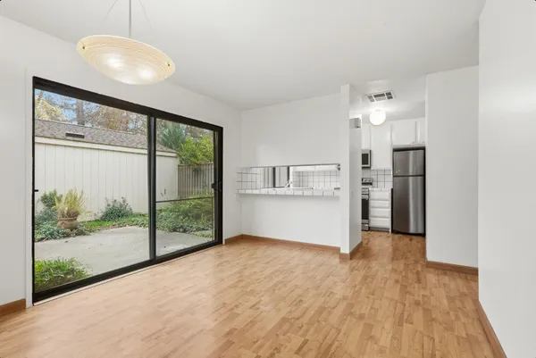 a view of a kitchen with a sink and refrigerator