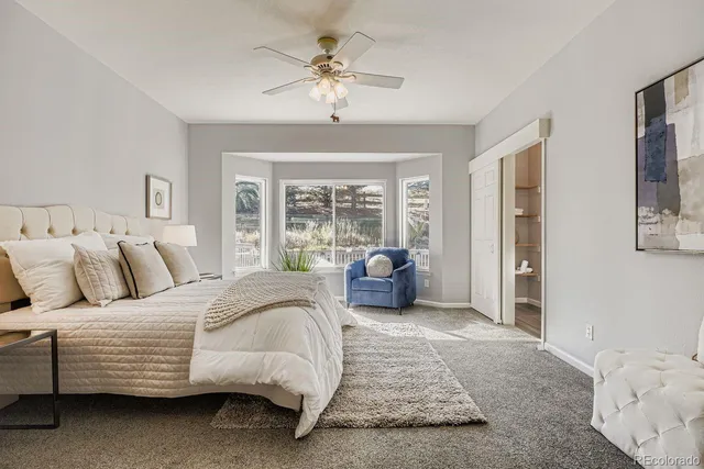 a spacious bedroom with a bed and glass door