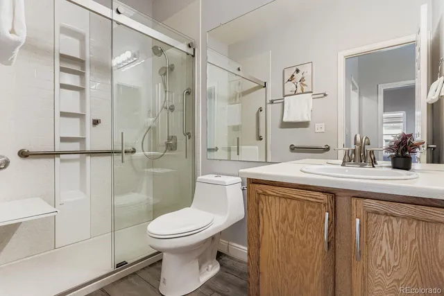 a bathroom with a toilet and a shower