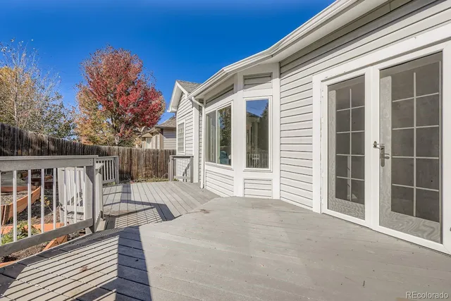 a view of house with wooden floor and fence