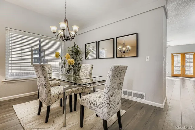 a view of a dining room with furniture and chandelier