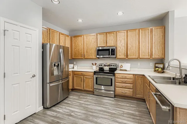 a kitchen with a refrigerator stove and sink