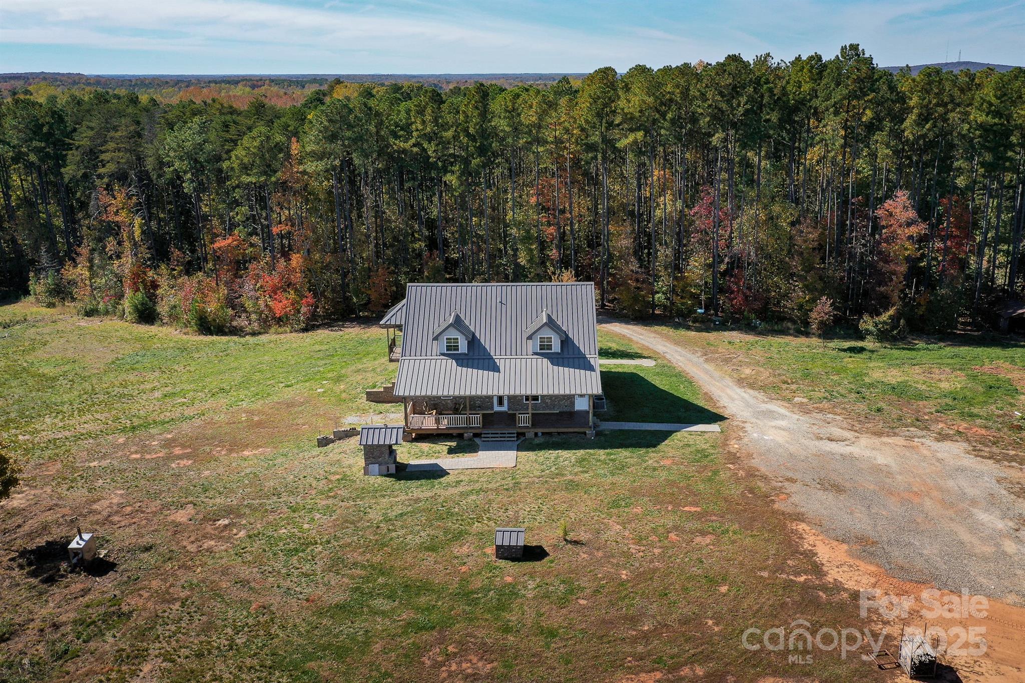 an aerial view of a house with garden space and street view
