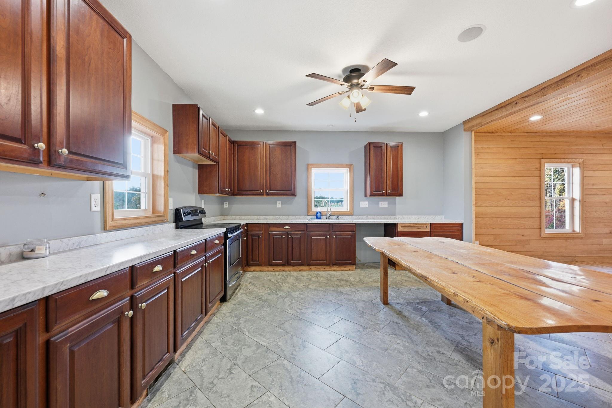 365 Kepley Road Salisbury, NC 28147 - Photo 21 of 48 a large kitchen with stainless steel appliances granite countertop a sink wooden cabinets and a counter top space