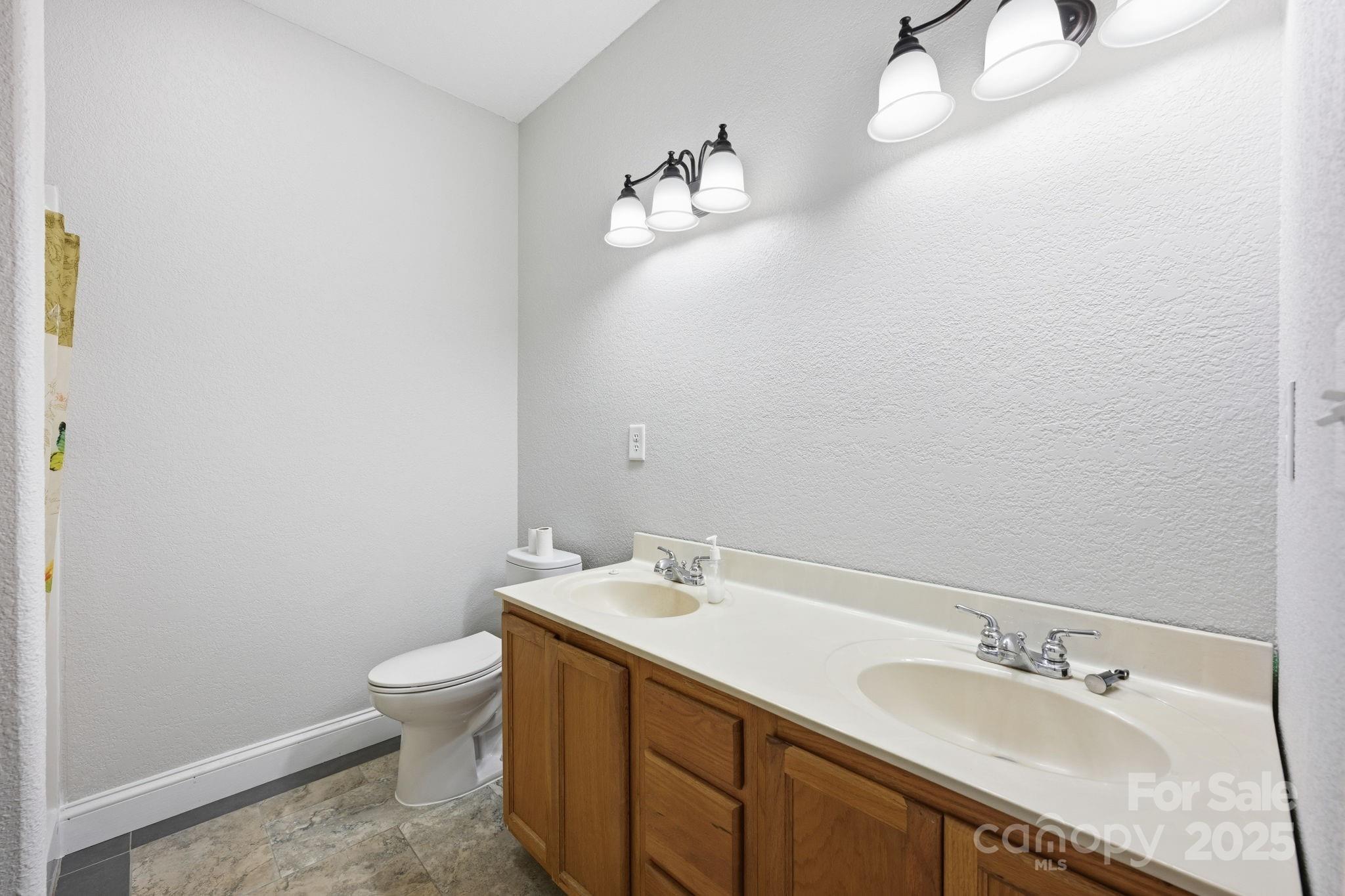 365 Kepley Road Salisbury, NC 28147 - Photo 25 of 48 a bathroom with a sink vanity and toilet