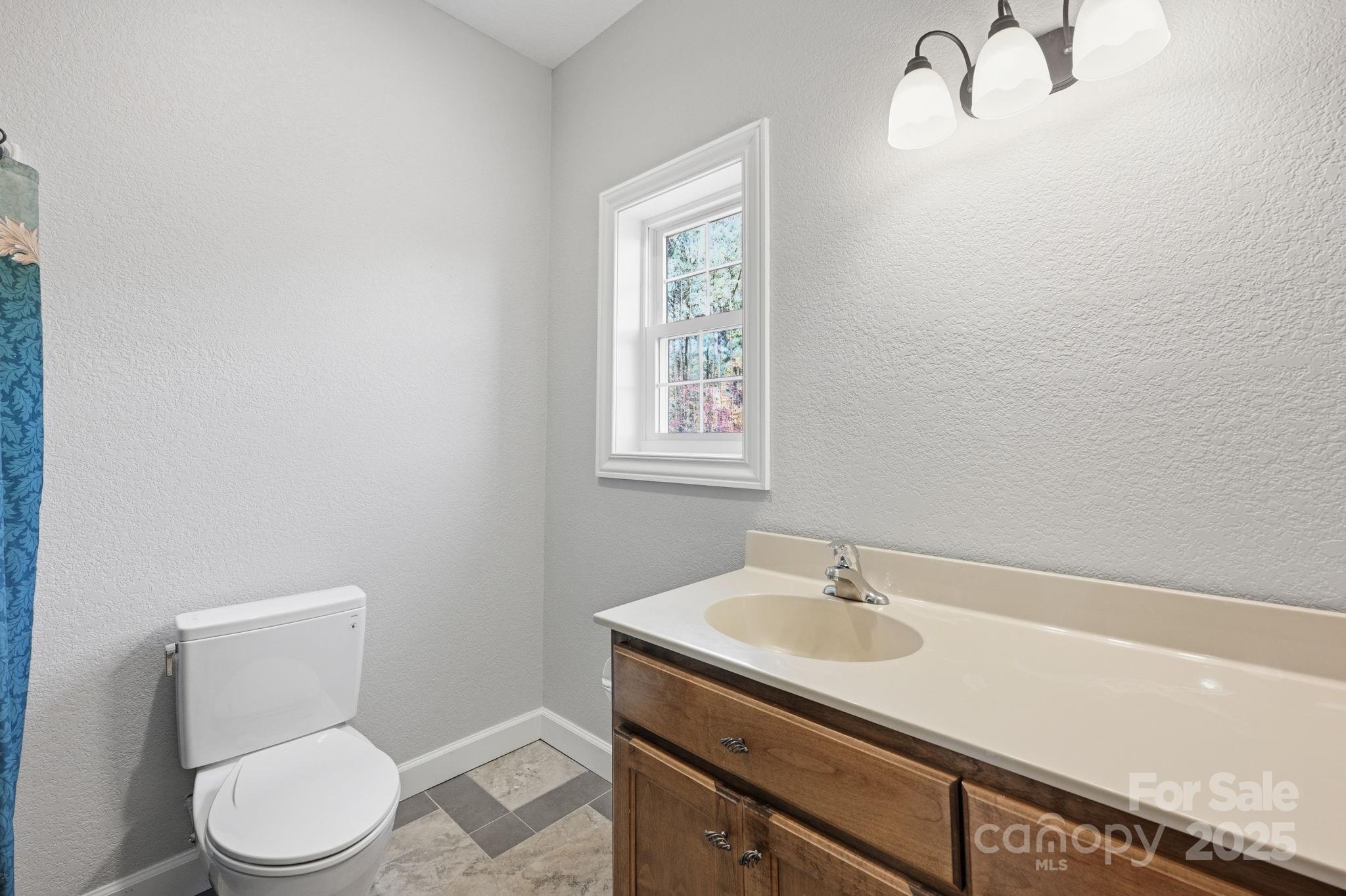365 Kepley Road Salisbury, NC 28147 - Photo 36 of 48 a bathroom with a toilet a sink and mirror