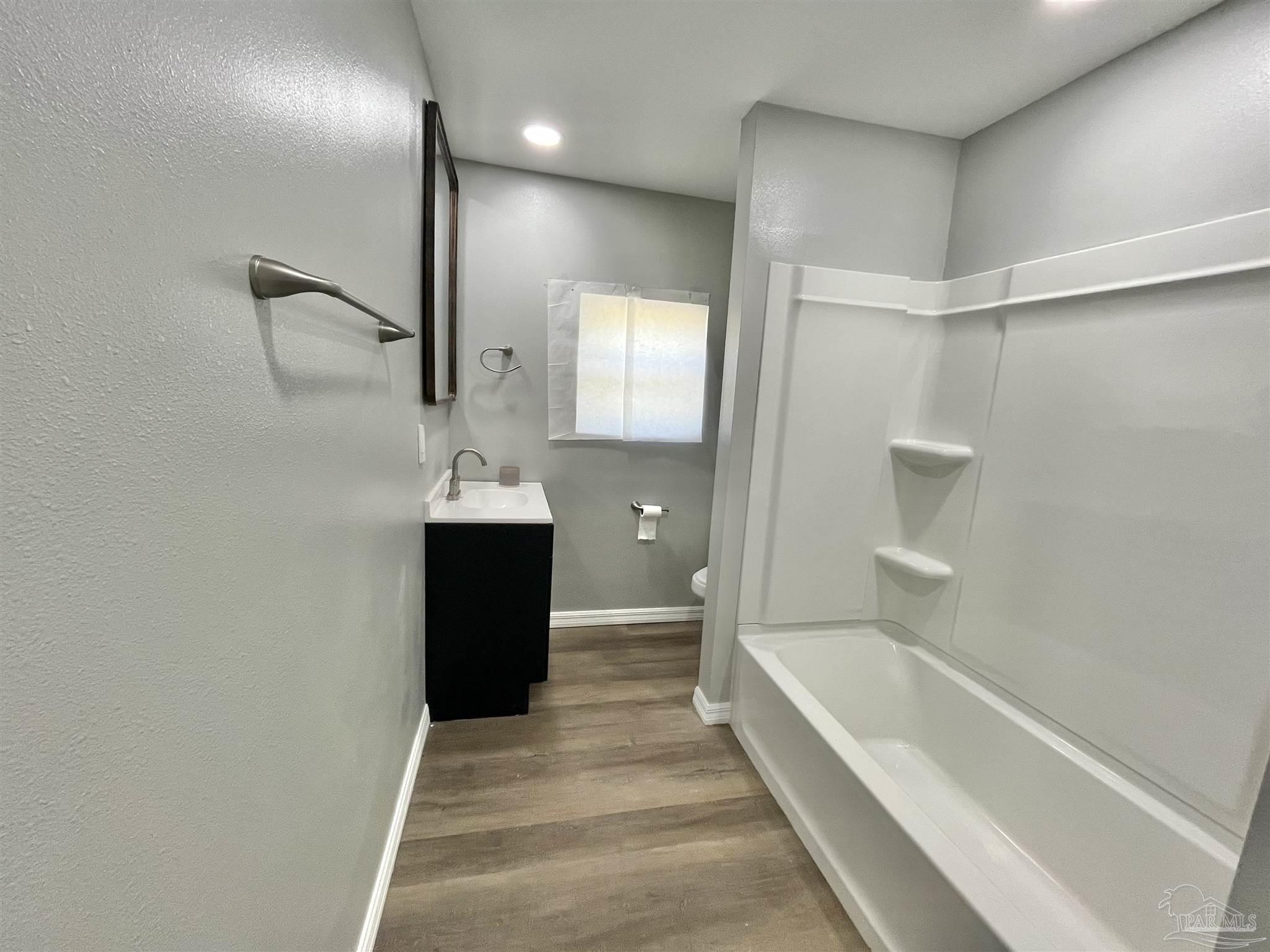 102 W Avenue Atmore, AL 36502 - Photo 17 of 25 a bathroom with a bathtub and a shower
