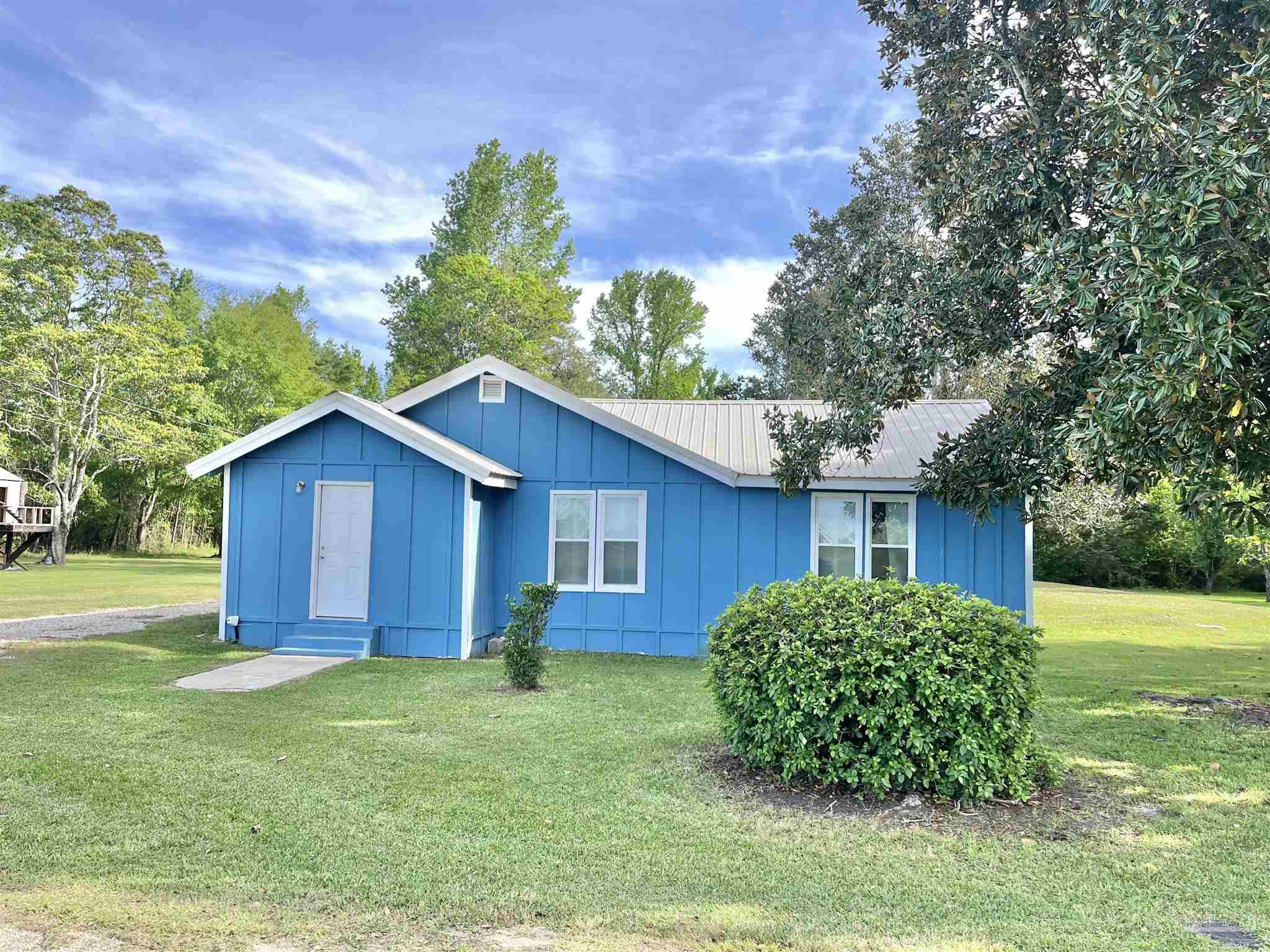 102 W Avenue Atmore, AL 36502 - Photo 2 of 25 a view of backyard of house with green space