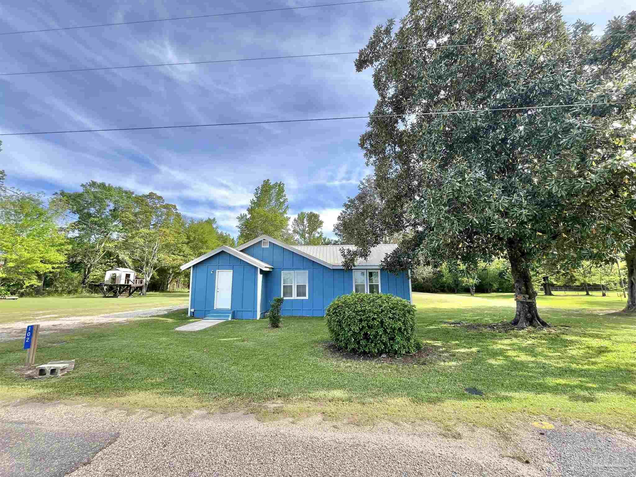 102 W Avenue Atmore, AL 36502 - Photo 21 of 25 a house view with a garden space